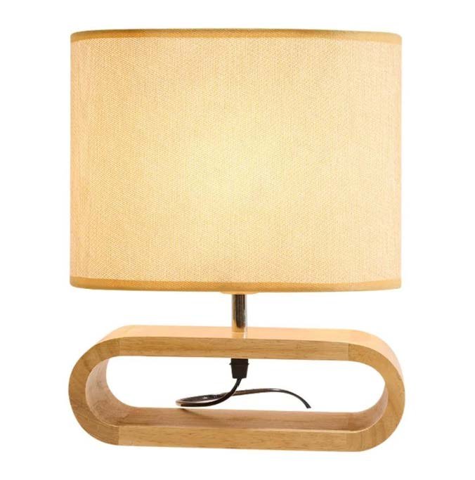 Modern bedside table lamp with oval wooden base and beige fabric shade